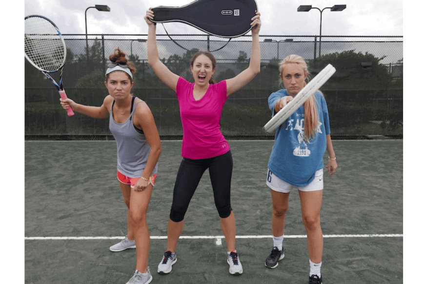 three women posing with tennis racquets on tennis courts