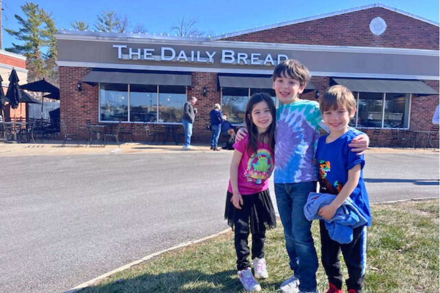 3 children standing outside The Daily Bread ready to dine