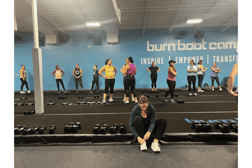 women line up on the signature "floating floor" with hand weights before class at Burn Boot Camp at Manchester.  