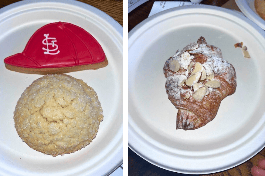 desserts from the Daily Bread.  iced sugar cookie in the shape of a St Louis Cardinals hat, large double sugar cookie.  flaky almond croissant topped with powdered sugar.