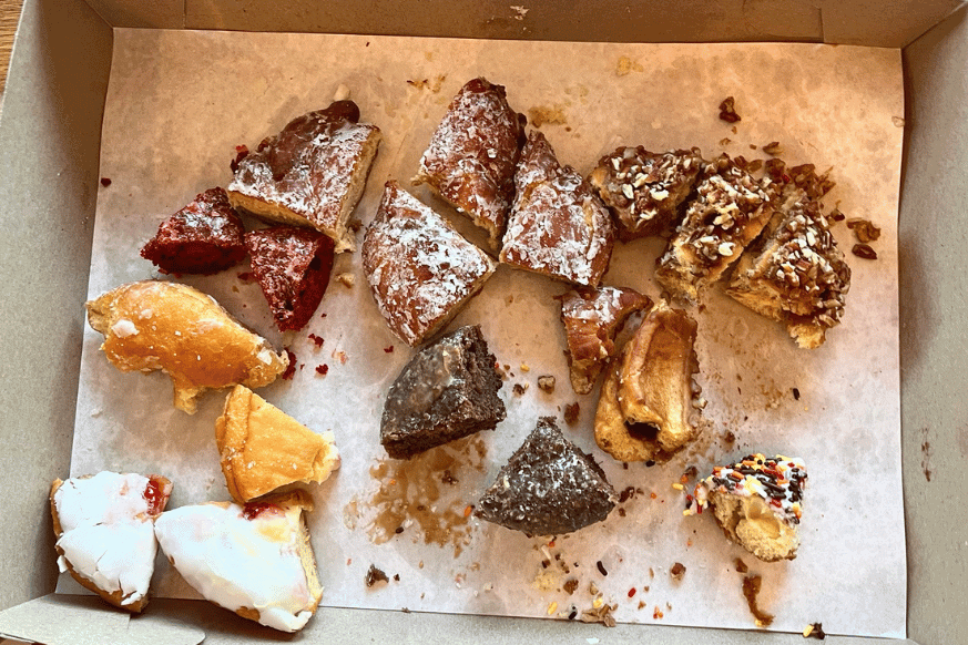 box of cut up donuts into small sample sized pieces for sharing