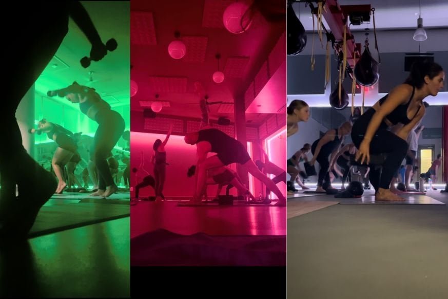 3 panel images.  one the left: crowded green lit room with multiple women wearing athletic wear standing on black mats and lifting weights in a back fly.  Center - red light room with multiple people doing a triangle yoga pose.  left: multiple people in low lit room lunging to the right while passing a pilates block under the leg.  