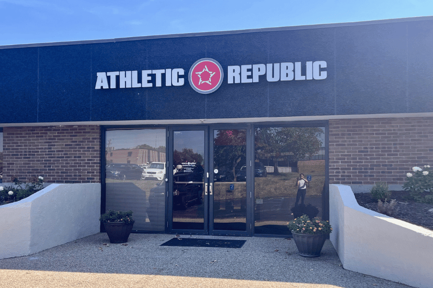 exterior entrance to Athletic Republic, which is housed in the same building as NutriFormance.  Shown with white bold logo and red star above the exterior doors.