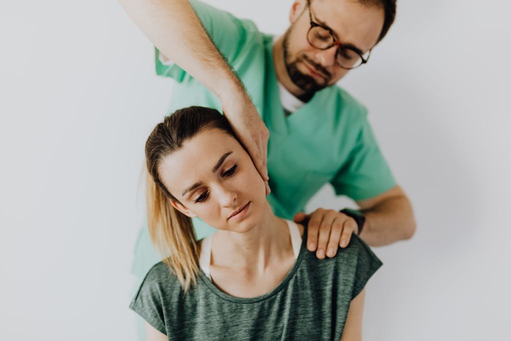 Professional Massage Therapist Treating a Female Patient's Injured Neck