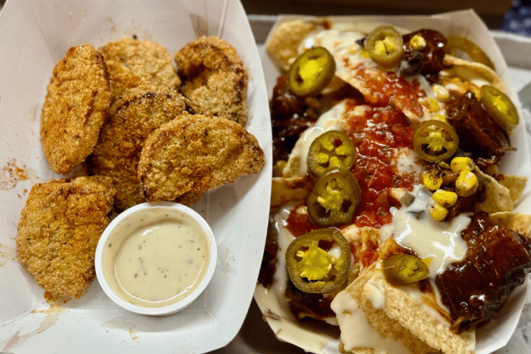 crispy tomato wedges with ranch dipping sauce on the left and nachos topped with white queso, jalepenos, salsa and more on the right