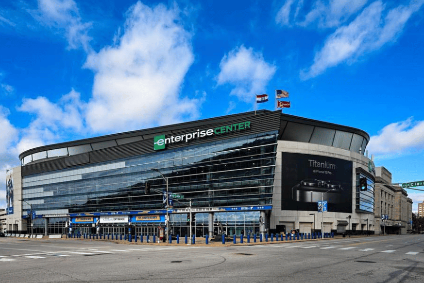 outside the enterprise center in st louis with a beautiful blue sky with white clouds as the backdrop