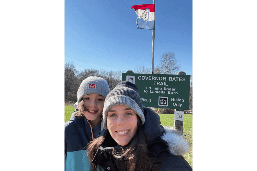 mother and nine year old son dressed warmly with hats at the start of govenor bates trail, a more challenging hike.